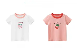 Detail view of cotton t-shirts with peach and strawberry graphics in white and pink