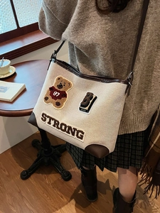 Retro canvas shoulder bag with cartoon bear embroidery and stylish leather trim details