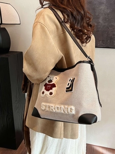 Retro canvas shoulder bag with plush bear patch and black leather trim for women