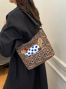 Vintage leopard print bucket bag with embroidered dog patch and knotted shoulder strap