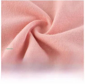 Macro shot of soft pink cotton knit fabric texture for girls short sleeve t-shirts