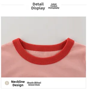 Detail of a pink knit t-shirt featuring a red ribbed crew neck and fine flat stitching