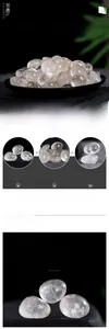 Close-up of polished clear quartz stones displayed on a black tray for home decor