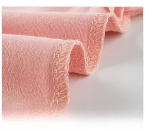 Detail shot of sturdy stitching and soft pink cotton fabric on the inner shirt lining