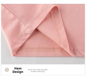 Detailed macro view of the double-stitched hem on pink cotton knit girls' t-shirt