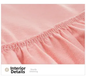 Dettaglio macro delle cuciture e dell'orlo interno di un abito rosa senza maniche