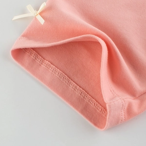Pink knitted girls leggings with a cute cream ribbon bow detail on the hem cuff
