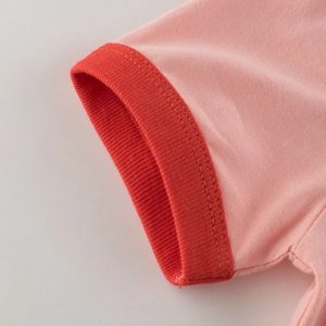 Pink knitted short-sleeved girl's T-shirt featuring red ribbed cuffs and fine texture