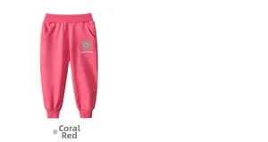 Detail of coral red girls joggers with elastic waist and blue flower graphic print