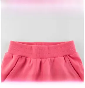 Detail view of pink girls' sports trousers featuring an elastic ribbed waistband design