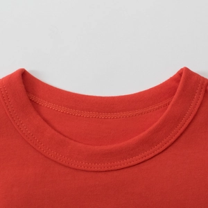Detail of red crewneck long-sleeve T-shirt collar with reinforced double stitching