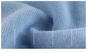 Detailed macro view of soft light blue knitted fabric with breathable cotton texture