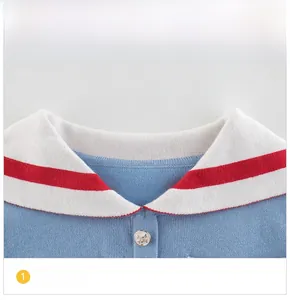 Detail of blue knit sweater collar with white lapel and red stripes decoration