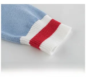 Close-up of sky blue knitted sleeve with red and white striped elastic ribbed cuffs
