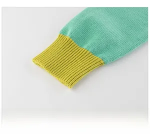 Detail of ribbed knit cuffs on kids' mint green and yellow cardigan sweater