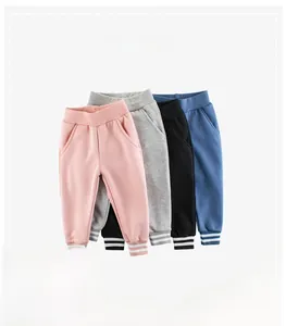 Detailed view of kids' cotton joggers showing ribbed striped cuffs and elastic waistbands