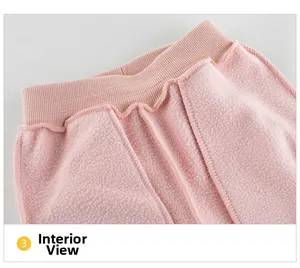 Detail of pink fleece lining and elastic ribbed waistband on toddler girl's pants