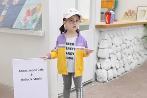 Detail of toddler girl purple patchwork zip jacket with white t-shirt and grey pants set