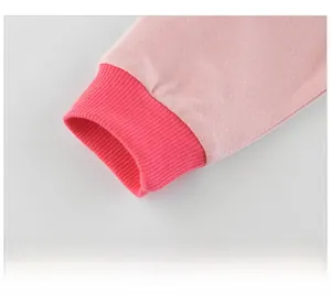Detail of pink knitted jacket showing elastic ribbed cuffs and high-quality fabric texture