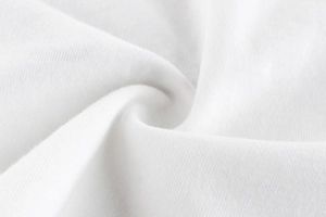 Detailed macro view of white soft knitted cotton fabric texture with fine weave patterns