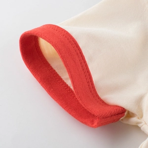 Détail de la manche d'un t-shirt pour fille avec bordure rouge en coton de qualité