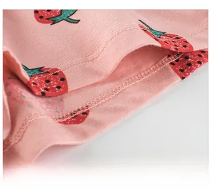 Detail of strawberry print on pink cotton fabric with high-quality hem stitching