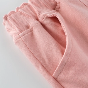 Pink cotton girls' shorts featuring an elastic waistband and premium stitching details