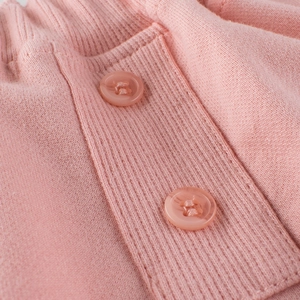 Girl's pink knitted shorts with elastic ribbed waistband and decorative buttons
