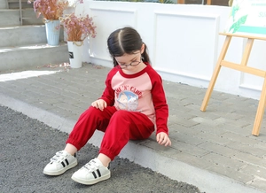 Detail of girls' long-sleeve cartoon printed tee and red joggers autumn set
