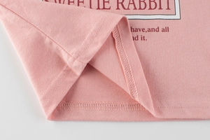 Close-up of pink knit girl's tee with Sweetie Rabbit print and fine double-stitched hem