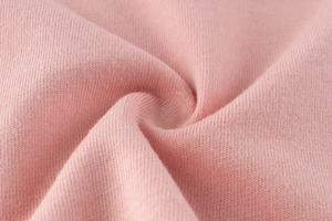 Close-up of pink knit fabric texture showing fine stitching and soft elastic material