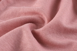 Macro shot of breathable mauve piqué fabric texture for children summer trousers