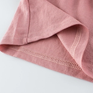 Pink pique knit kids polo shirt featuring high-quality stitching and textured fabric