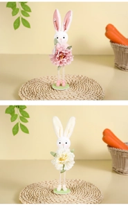 Detail of plush Easter bunnies with long ears holding large artificial spring flowers