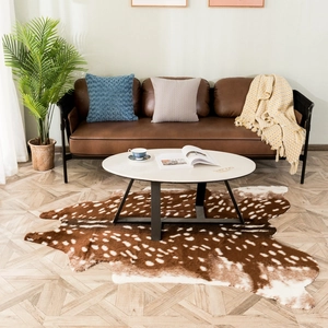 Faux deer hide rug with white spots on dark brown background for home decor