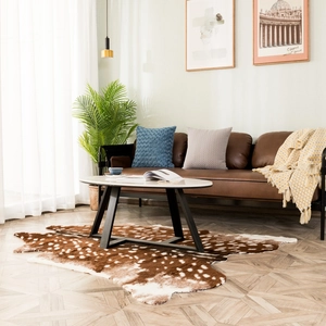 Detailed texture of brown faux sika deer fur rug with white spots in a cozy living room