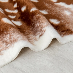 Detail of plush faux sika deer fur rug showing soft texture and brown white spots