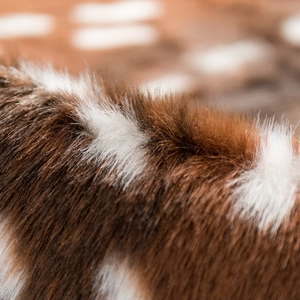 Plush faux fur sika deer print area rug showing soft fiber texture and natural brown spots