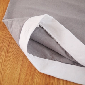 Detail of grey non-woven fabric Christmas chair cover with white hem and soft texture