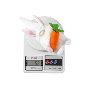 Close-up of Easter gnome plush with bunny ears and carrot, weighing 52 grams on scale