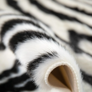 Modern black and white zebra pattern rug with soft faux fur texture and durable edge piping
