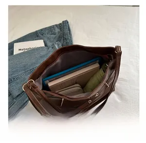 Detail shot showing the large internal capacity of the dark brown leather tote bag