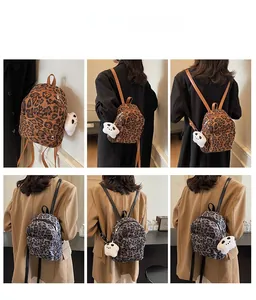 Mini leopard print backpacks in brown and gray with cute bear charms on model