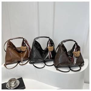 Detailed view of large vintage tote bags in brown, black, and coffee with bear charms