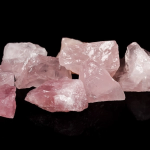 Natural rose quartz crystal raw stones with translucent texture and ice crack details