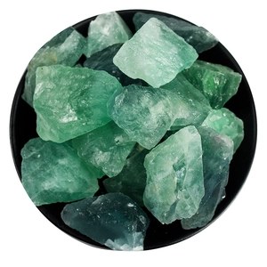 Natural green fluorite raw crystal stones for aromatherapy in a black bowl