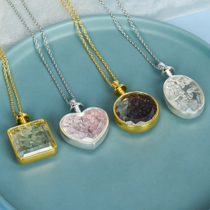 Multiple crystal chip necklaces in heart, round, and square shapes on a blue plate