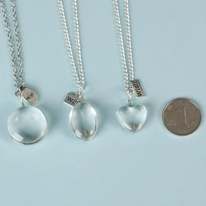 Handmade dandelion seed glass pendant necklaces in round, oval, and heart shapes with wish tag