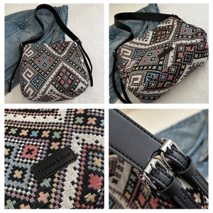 Close-up of geometric pattern canvas bag with adjustable leather strap and metal buckle