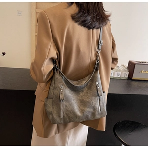 Detail of vintage grey tote bag showing vertical zipper pockets and side slip pockets